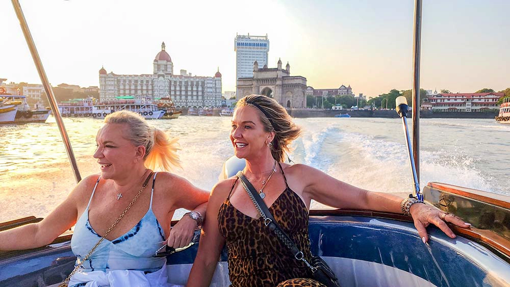 Traveler enjoying a premium speedboat ride near the Gateway of India and Taj Mahal Palace Hotel before departing for Elephanta Caves in Mumbai.