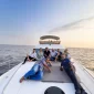Guests relaxing on a private yacht during a scenic sea cruise experience in Mumbai.