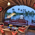 Evening view from a Kerala houseboat cruising through palm-lined backwaters