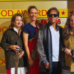 Group of visitors posing with a Bollywood actor statue at a film awards–themed exhibit