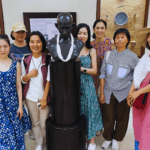 Travelers visiting Mahatma Gandhi museum exhibit during Highlights of Mumbai guided heritage tour