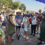 Guided group of international tourists listening to a local guide during a Mumbai city sightseeing tour in India