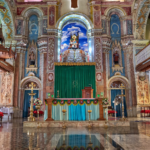 Ornate church interior in Old Goa with altar and arches