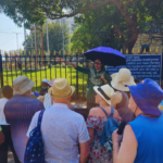 Local guide explaining Mumbai history to tour group during a guided city sightseeing tour