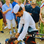 Mumbai dabbawala demonstrating lunchbox delivery system to tourists during a guided city tour
