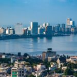Mumbai skyline at Marine Drive during blue hour with city buildings and curved coastline
