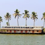 Traditional Kerala houseboat cruising through scenic backwaters near Kochi