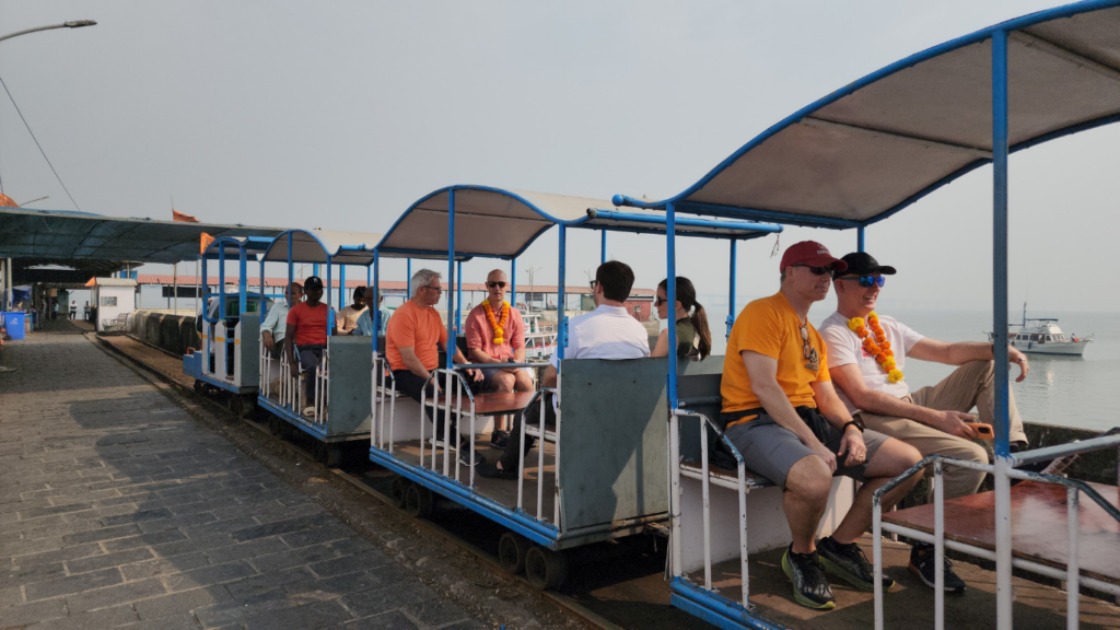 Visitors riding the Elephanta Island toy train after arriving on a luxury Elephanta Caves private speedboat tour